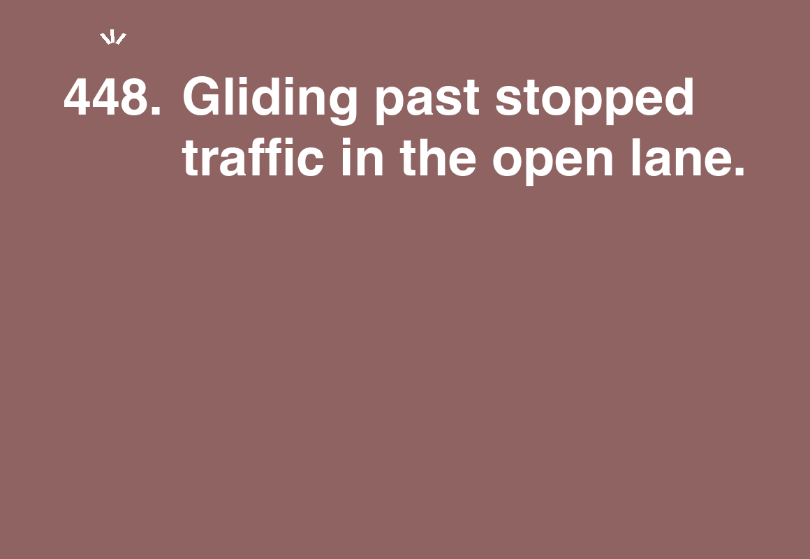 Gliding past stopped traffic in the open lane. — card 448 of the 1000 little things list